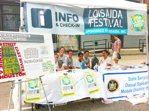 Volunteers at a check-in both at the NYC Loisaida Festival